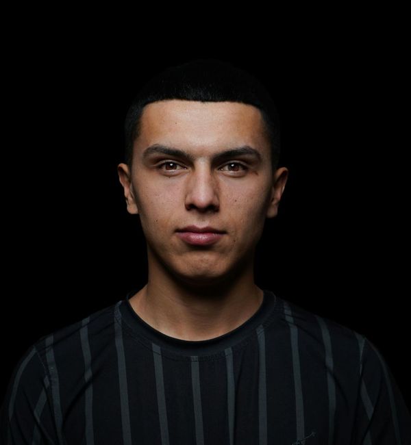 Silhouette of a man standing confidently against a dark background.